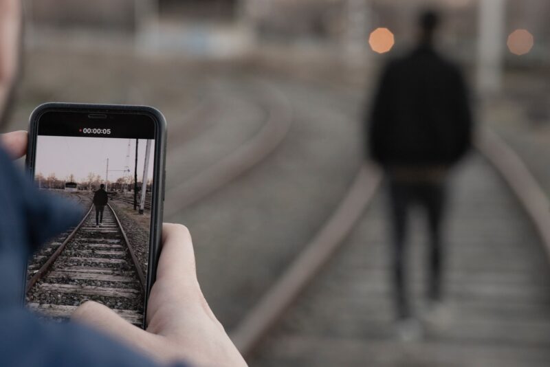 unknown person using smartphone outdoors